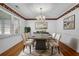 Well-lit dining room featuring hardwood floors, white walls, and an elegant chandelier at 223 Ivy Creek Dr, Loganville, GA 30052