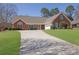 Charming brick home features an attached two-car garage and a well-manicured front yard at 223 Ivy Creek Dr, Loganville, GA 30052