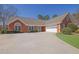 Charming brick home features an attached two-car garage and a well-manicured front yard at 223 Ivy Creek Dr, Loganville, GA 30052