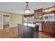 A kitchen featuring stainless steel appliances, an island with a granite countertop, and wooden floors at 223 Ivy Creek Dr, Loganville, GA 30052