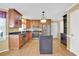 Kitchen with stainless steel appliances, dark countertops and wood cabinets at 223 Ivy Creek Dr, Loganville, GA 30052