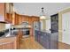 A kitchen featuring stainless steel appliances, an island with a granite countertop, and wooden cabinets at 223 Ivy Creek Dr, Loganville, GA 30052