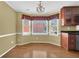 Kitchen nook with hardwood floors, bay windows, and stainless steel appliances at 223 Ivy Creek Dr, Loganville, GA 30052