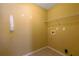Tiled laundry room with connections for a washer and dryer, and a storage shelf at 223 Ivy Creek Dr, Loganville, GA 30052