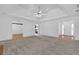The living room features a ceiling fan and doorways to other rooms at 223 Ivy Creek Dr, Loganville, GA 30052
