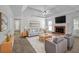 The living room features a fireplace, ceiling fan, and a neutral color palette at 223 Ivy Creek Dr, Loganville, GA 30052