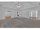 Spacious living room with carpet, white walls, and a ceiling fan at 223 Ivy Creek Dr, Loganville, GA 30052