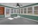 The sunroom features several windows and a ceiling fan at 223 Ivy Creek Dr, Loganville, GA 30052