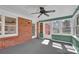 The sunroom features a brick wall, a ceiling fan, and several windows at 223 Ivy Creek Dr, Loganville, GA 30052