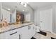 Bathroom features granite countertops, white cabinets with black hardware, and modern fixtures at 250 Pharr Ne Rd # 1702, Atlanta, GA 30305