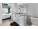 This bathroom features granite countertops, white cabinets with black hardware, and a glimpse of the bedroom at 250 Pharr Ne Rd # 1702, Atlanta, GA 30305