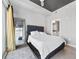 Cozy bedroom featuring a tufted headboard, large window, and view to the living room at 250 Pharr Ne Rd # 1702, Atlanta, GA 30305