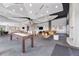 Spacious community space featuring a bar, dining area, pool table, seating, and modern lighting at 250 Pharr Ne Rd # 1702, Atlanta, GA 30305