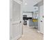 Hallway view leading into the kitchen area showcasing modern design and ample lighting at 250 Pharr Ne Rd # 1702, Atlanta, GA 30305
