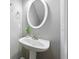 Bathroom featuring pedestal sink, oval mirror and modern fixtures at 3258 Welmingham Sw Dr, Atlanta, GA 30331