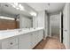 Bright primary bathroom with dual sinks, tile floors, a walk in shower, and lots of counter space at 3258 Welmingham Sw Dr, Atlanta, GA 30331