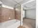 Bathroom featuring bathtub with tile surround and a view to the bedroom at 3258 Welmingham Sw Dr, Atlanta, GA 30331