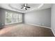 Spacious bedroom with tray ceiling, fan and natural light from three large windows at 3258 Welmingham Sw Dr, Atlanta, GA 30331