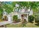 Charming two-story home with a well-manicured lawn, a two-car garage and beautiful trees in a suburban neighborhood at 3258 Welmingham Sw Dr, Atlanta, GA 30331