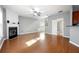 Spacious living room with fireplace, hardwood floors, and open access to stairway and back hall at 3258 Welmingham Sw Dr, Atlanta, GA 30331
