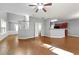 Large living room with open floor plan, hardwood floors, and natural light, shared with kitchen space at 3258 Welmingham Sw Dr, Atlanta, GA 30331