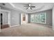 Sunlit main bedroom features tray ceiling, plush carpet and ensuite bathroom at 3258 Welmingham Sw Dr, Atlanta, GA 30331