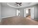Large bedroom featuring a tray ceiling, ensuite bath and walk in closet at 3258 Welmingham Sw Dr, Atlanta, GA 30331