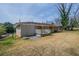 Backyard view of a single-story brick home with a small white deck at 4094 E Glade Ct, Decatur, GA 30035