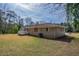 Backyard view of a single-story brick home with a small white deck at 4094 E Glade Ct, Decatur, GA 30035