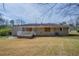 Backyard view of a single-story brick home with a small white deck at 4094 E Glade Ct, Decatur, GA 30035