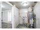 Basement area featuring exposed brick and hot water tank at 4094 E Glade Ct, Decatur, GA 30035