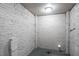 Basement area with exposed brick and lighting fixtures at 4094 E Glade Ct, Decatur, GA 30035
