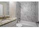 Modern bathroom featuring stylish marble tile in the shower and a granite-look vanity at 4094 E Glade Ct, Decatur, GA 30035