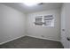 Bedroom with grey carpet, window with blinds, and white door at 4094 E Glade Ct, Decatur, GA 30035