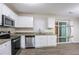 Modern kitchen featuring stainless steel appliances, granite countertops, and wood flooring at 4094 E Glade Ct, Decatur, GA 30035