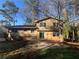 View of the home's backyard and exterior showing neutral siding and windows at 4820 Banner Elk Dr, Stone Mountain, GA 30083
