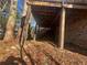 View of backyard, showing the underside of the wooden deck with access to yard at 4820 Banner Elk Dr, Stone Mountain, GA 30083