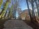 Exterior view of driveway approaching the house, showing the garage and stone facade at 4820 Banner Elk Dr, Stone Mountain, GA 30083
