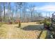 Large backyard with an expansive lawn, mature trees, and a privacy fence at 165 Babbling Brook, Mcdonough, GA 30252