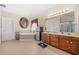Bathroom features corner tub, dual vanities with cabinets, and a stainless steel refrigerator for convenience at 165 Babbling Brook, Mcdonough, GA 30252