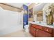 This bathroom includes a tub and shower combo with wood cabinetry and decorative artwork at 165 Babbling Brook, Mcdonough, GA 30252