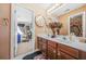 Bathroom features a double vanity with framed mirrors, overhead lighting, and a view into the bedroom at 165 Babbling Brook, Mcdonough, GA 30252
