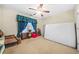 Bedroom featuring a ceiling fan, blue print curtains, upholstered chairs, a red stool and mattress on the floor at 165 Babbling Brook, Mcdonough, GA 30252