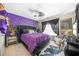 Modern bedroom showcasing an upholstered bed, statement wall, ceiling fan, statement wall, and zebra rug at 165 Babbling Brook, Mcdonough, GA 30252