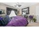 This bedroom features a plush bed, a unique fan, and a decorative mirror, creating a stylish and inviting space at 165 Babbling Brook, Mcdonough, GA 30252