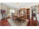 Dining room featuring a chandelier, cherry hardwood floors, and formal wood furniture at 165 Babbling Brook, Mcdonough, GA 30252