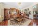 Formal dining room boasts a chandelier, hardwood floors, and elegant furniture at 165 Babbling Brook, Mcdonough, GA 30252