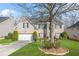Two-story brick home with black shutters, a well-manicured lawn, and mature landscaping at 165 Babbling Brook, Mcdonough, GA 30252