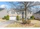 Two-story brick home with black shutters, a well-manicured lawn, and mature landscaping at 165 Babbling Brook, Mcdonough, GA 30252