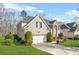 Beautiful two-story brick home with an attached garage, green lawn, and manicured greenery at 165 Babbling Brook, Mcdonough, GA 30252
